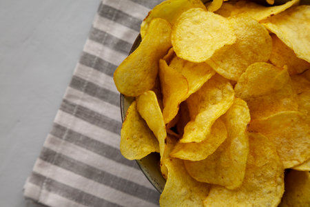 Homemade Kettle Cooked Potato Chips with Salt in a Bowl, top view. Copy space.の写真素材