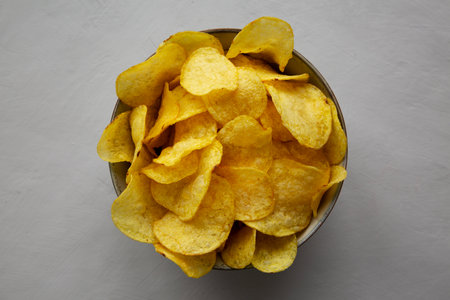 Homemade Kettle Cooked Potato Chips with Salt in a Bowl, top view.