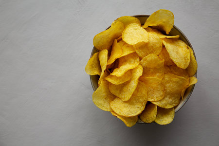Homemade Kettle Cooked Potato Chips with Salt in a Bowl, top view.