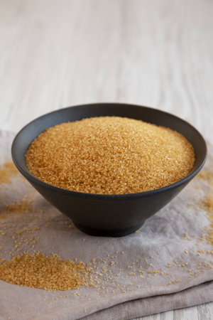 Organic Demerara Sugar in a Bowl, side view. Close-up.の写真素材