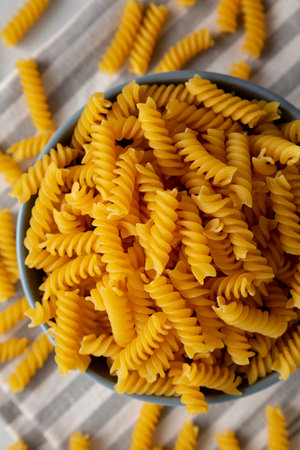 Dry Fusilli Pasta in a Bowl, top view. Flat lay, overhead, from above. Close-up.の写真素材