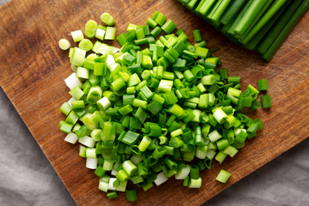 Organic Cut Green Onion Scallions on a Wooden Board, top view.の写真素材