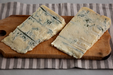 Blue cheese Gorgonzola on a Wooden Board, side view.の写真素材