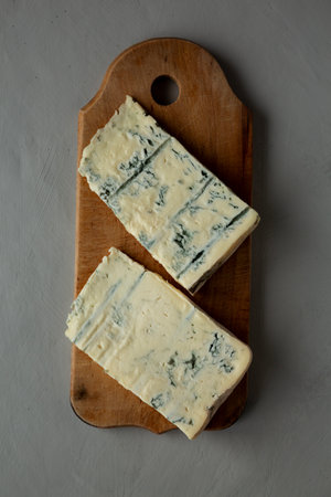 Blue cheese Gorgonzola on a Wooden Board, top view.の写真素材