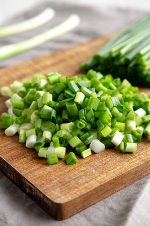 Organic Cut Green Onion Scallions on a Wooden Board, side view. Close-up.の写真素材