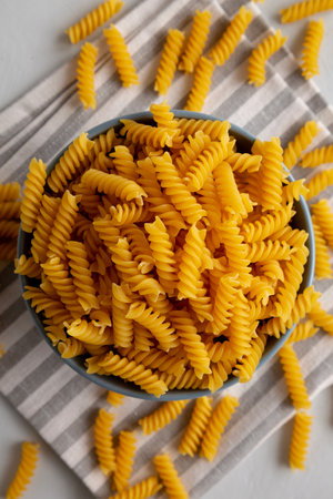 Dry Fusilli Pasta in a Bowl, top view. Flat lay, overhead, from above.の写真素材