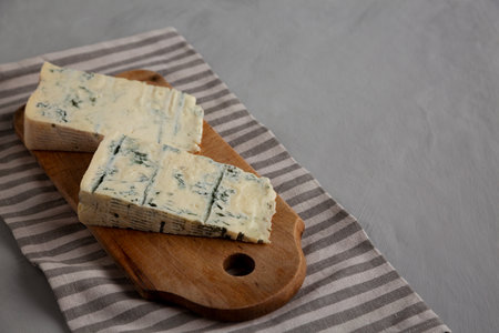 Blue cheese Gorgonzola on a Wooden Board, side view. Copy space.の写真素材