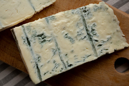 Blue cheese Gorgonzola on a Wooden Board, top view.の写真素材