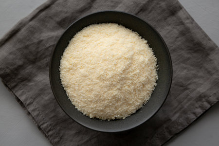 Organic Parmigiano Reggiano Parmesan Cheese Grated in a Bowl, top view.の写真素材