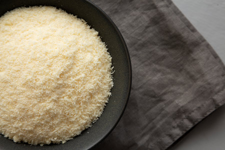 Organic Parmigiano Reggiano Parmesan Cheese Grated in a Bowl, top view. Copy space.の写真素材
