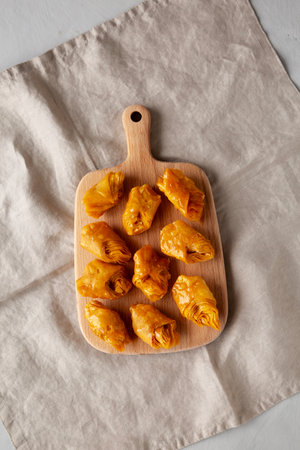 Sweet Homemade Turkish Baklava with Honey on a Wooden Board, top view.の写真素材