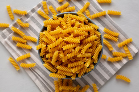 Dry Fusilli Pasta in a Bowl, top view. Flat lay, overhead, from above.の写真素材