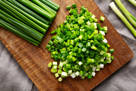 Organic Cut Green Onion Scallions on a Wooden Board, top view.の写真素材