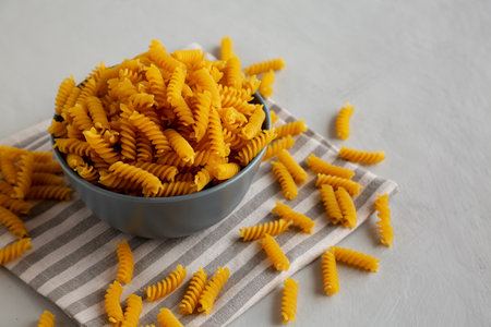 Dry Fusilli Pasta in a Bowl, side view. Copy space.の写真素材