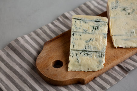Blue cheese Gorgonzola on a Wooden Board, side view.の写真素材