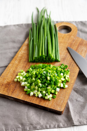 Organic Cut Green Onion Scallions on a Wooden Board, side view.の写真素材