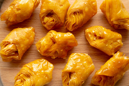 Sweet Homemade Turkish Baklava with Honey on a Wooden Board, top view. Close-up.の写真素材