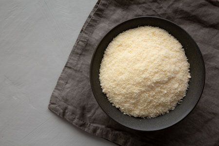 Organic Parmigiano Reggiano Parmesan Cheese Grated in a Bowl, top view. Copy space.の写真素材
