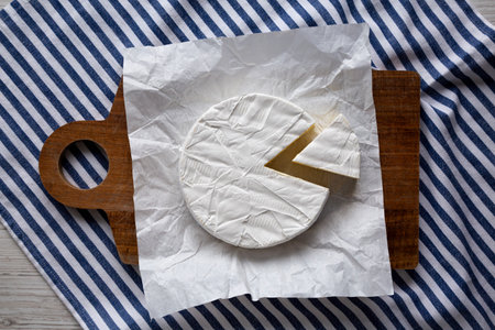 Homemade White Brie Cheese on a Wooden Board, top view.の写真素材