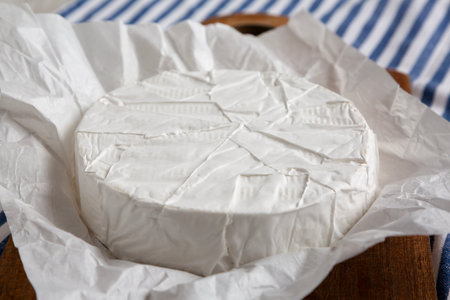 Homemade White Brie Cheese on a Wooden Board, side view.の写真素材
