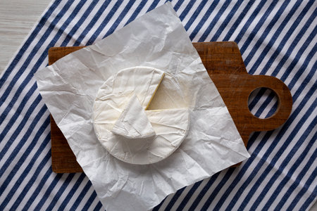 Homemade White Brie Cheese on a Wooden Board, top view.の写真素材
