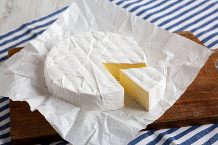Homemade White Brie Cheese on a Wooden Board, side view.の写真素材