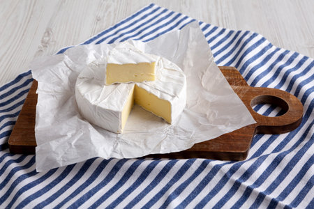 Homemade White Brie Cheese on a Wooden Board, side view.の写真素材