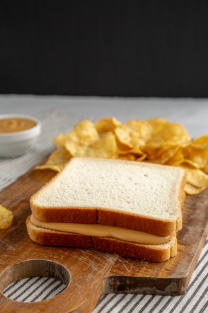 Homemade American Peanut Butter Sandwich on a Wooden Board, side view.の写真素材