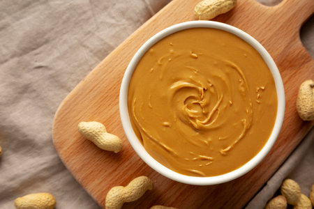 Organic Peanut Butter in a Bowl, top view. Flat lay, overhead.