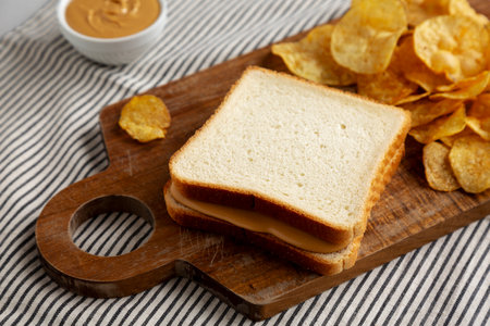 Homemade American Peanut Butter Sandwich on a Wooden Board, side view.の写真素材
