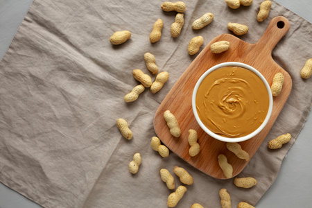 Organic Peanut Butter in a Bowl, top view. Flat lay, overhead. Copy space.の写真素材