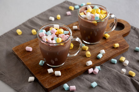 Warm Chocolate Cocoa in Mugs with Colorful Marshmallows, side view.の写真素材