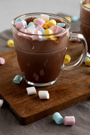 Warm Chocolate Cocoa in Mugs with Colorful Marshmallows, side view.の写真素材
