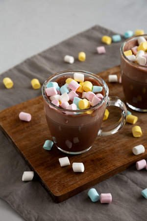 Warm Chocolate Cocoa in Mugs with Colorful Marshmallows, side view.の写真素材
