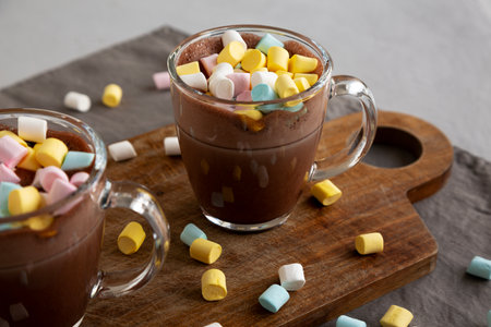 Warm Chocolate Cocoa in Mugs with Colorful Marshmallows, side view.の写真素材