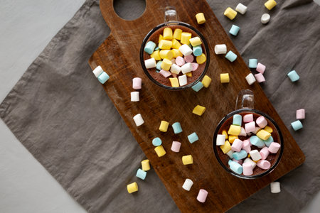 Warm Chocolate Cocoa in Mugs with Colorful Marshmallows, top view.の写真素材