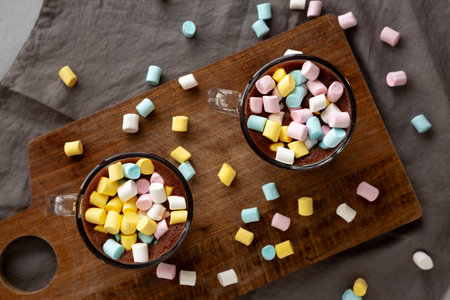 Warm Chocolate Cocoa in Mugs with Colorful Marshmallows, top view. Overhead, from above.の写真素材