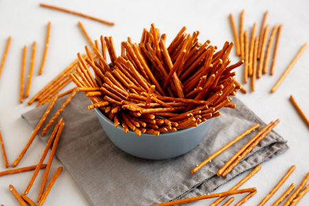 Organic Salty Pretzel Sticks in a Bowl, side view.の写真素材