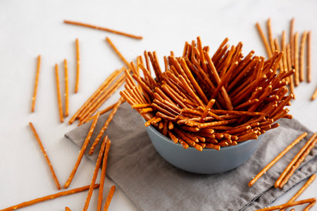 Organic Salty Pretzel Sticks in a Bowl, side view.の写真素材