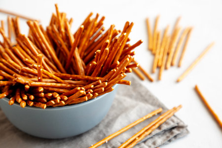 Organic Salty Pretzel Sticks in a Bowl, side view.の写真素材