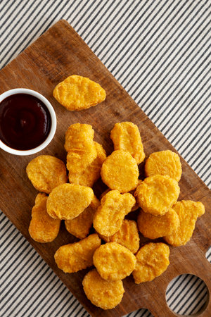 Organic Fried Chicken Nuggets on a wooden board, top view. Copy space.の写真素材