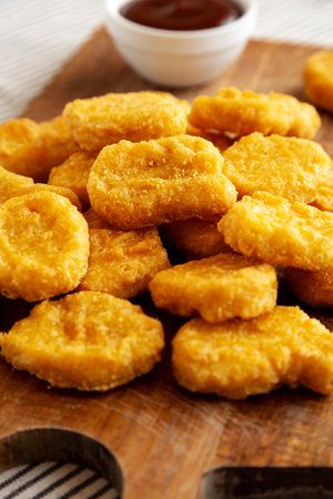 Organic Fried Chicken Nuggets on a wooden board, side view. Close-up.の写真素材