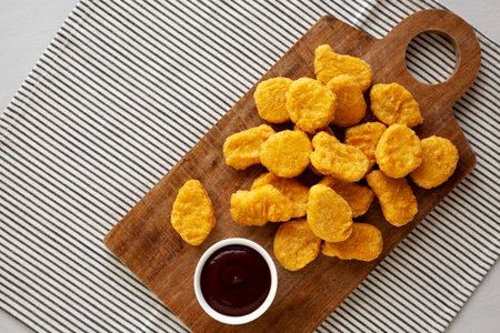 Organic Fried Chicken Nuggets on a wooden board, top view. Copy space.の写真素材