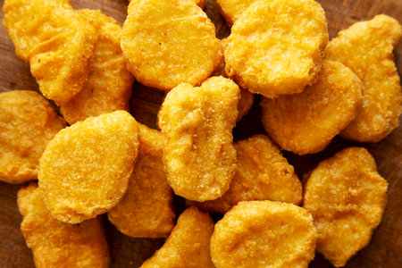 Organic Fried Chicken Nuggets on a wooden board, top view. Close-up.の写真素材
