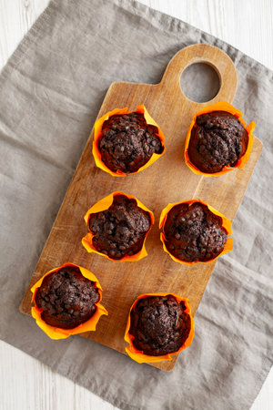 Homemade Chocolate Chip Muffins on a wooden board, top view.の写真素材