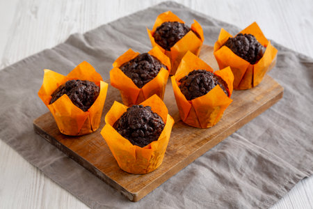 Homemade Chocolate Chip Muffins on a wooden board, side view.の写真素材