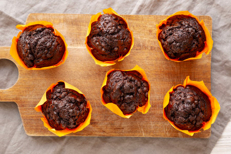 Homemade Chocolate Chip Muffins on a wooden board, top view.の写真素材