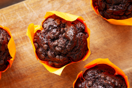 Homemade Chocolate Chip Muffins on a wooden board, top view. Close-up.の写真素材