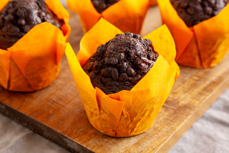 Homemade Chocolate Chip Muffins on a wooden board, side view. Close-up.の写真素材