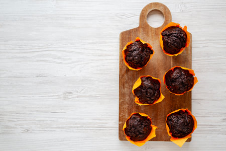 Homemade Chocolate Chip Muffins on a wooden board, top view. Copy space.の写真素材